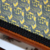 detail of bench design fabric linen weight mustard metal, black trim, wooden edge
