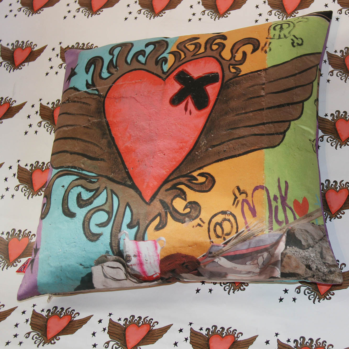 graffiti art with heart with wings cushion on heart design background