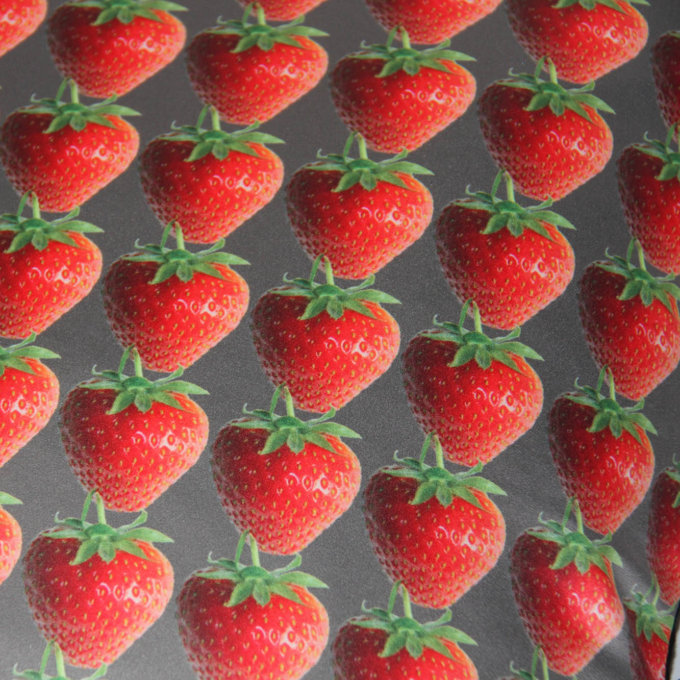 real strawberries in linear design, close up of fabric