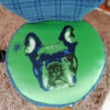 View of round seat of chair from above showing French bulldog face