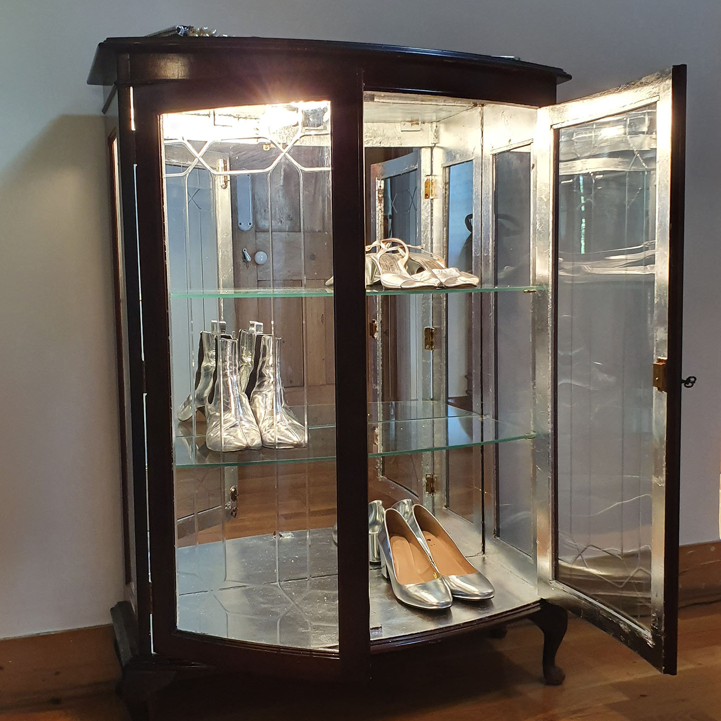 vintage glass cabinet, dark wood, mirrored back, glass shelves, electric light, silver leafed inside