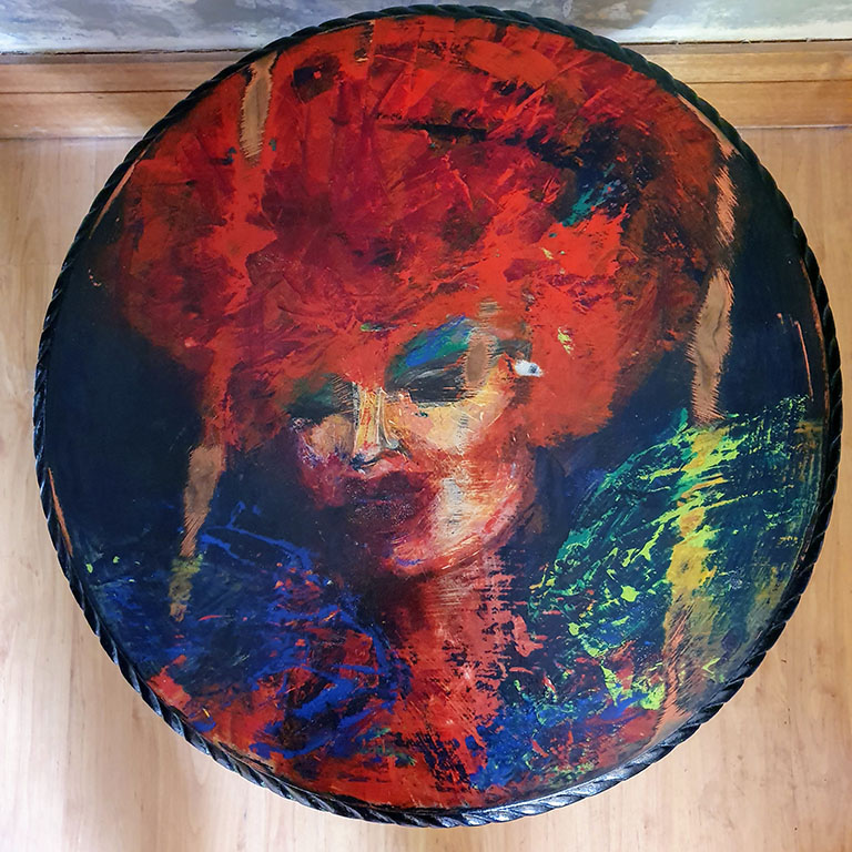 round table top with handprinted drag queen face