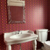 graffiti heart wallpaper by Claire Swindale in cloakroom with mirror white sink and toilet